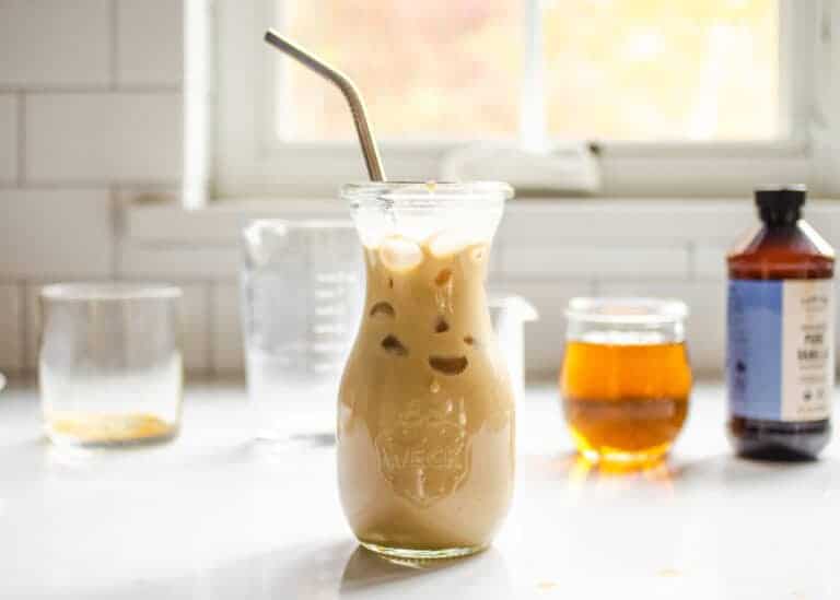 A homemade Starbucks bottled Frappuccino on a countertop with the ingredients behind it.