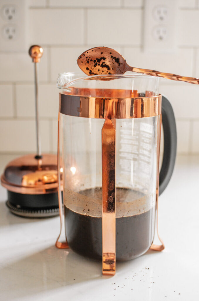Stirring the coffee and water together in the French press.