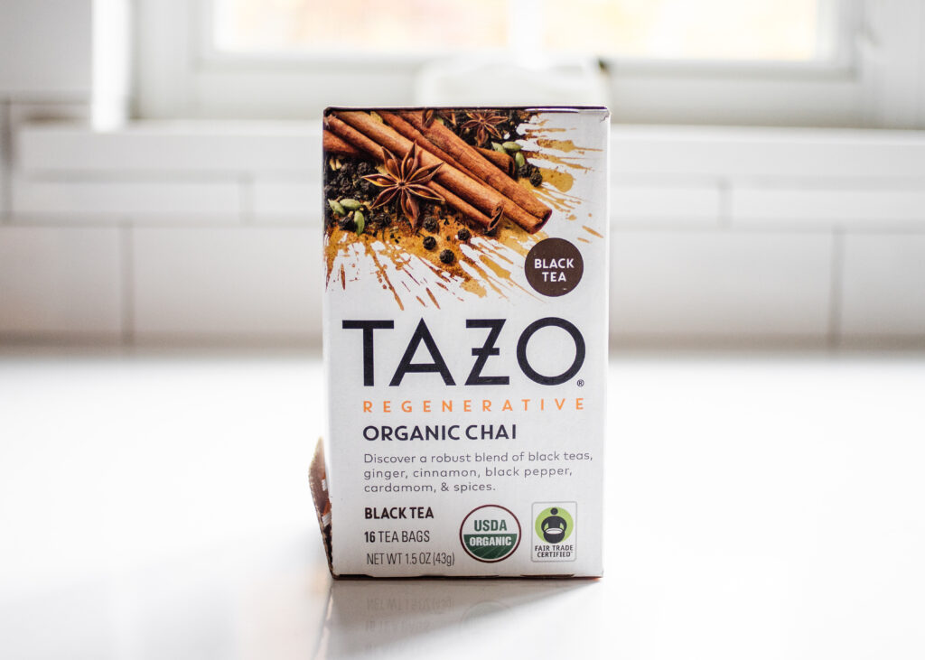 TAZO organic chai tea on a white countertop.