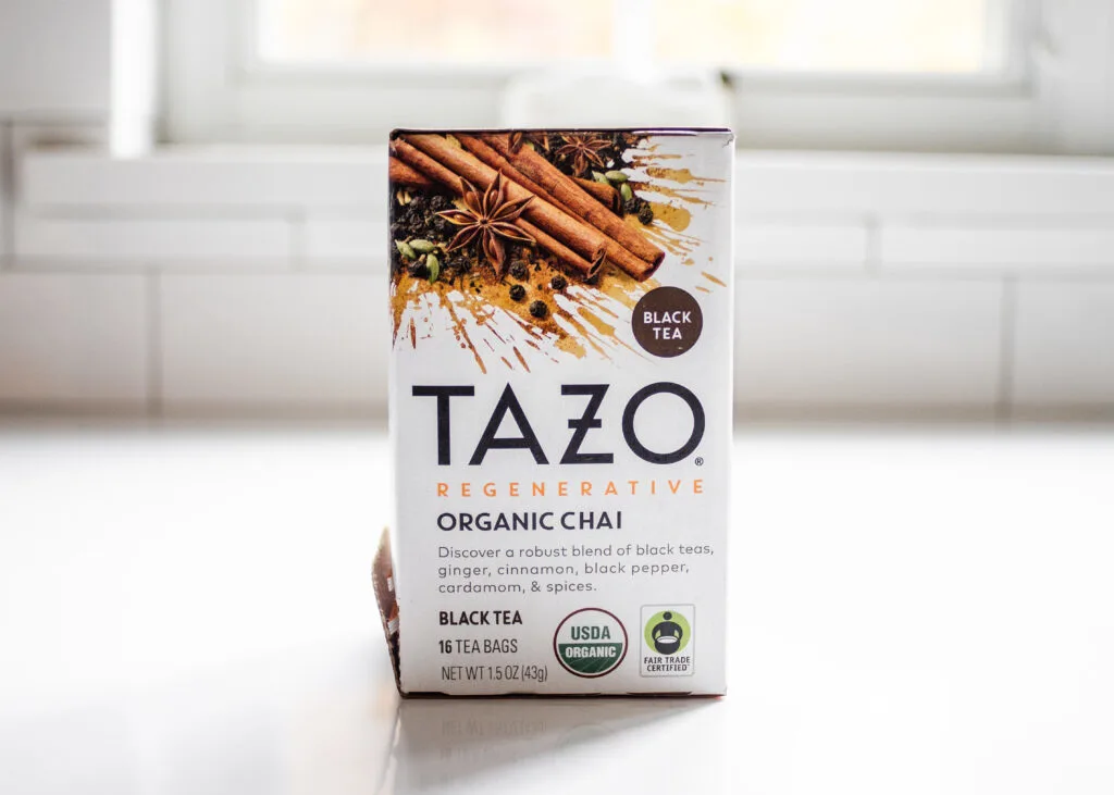 TAZO organic chai tea on a white countertop.