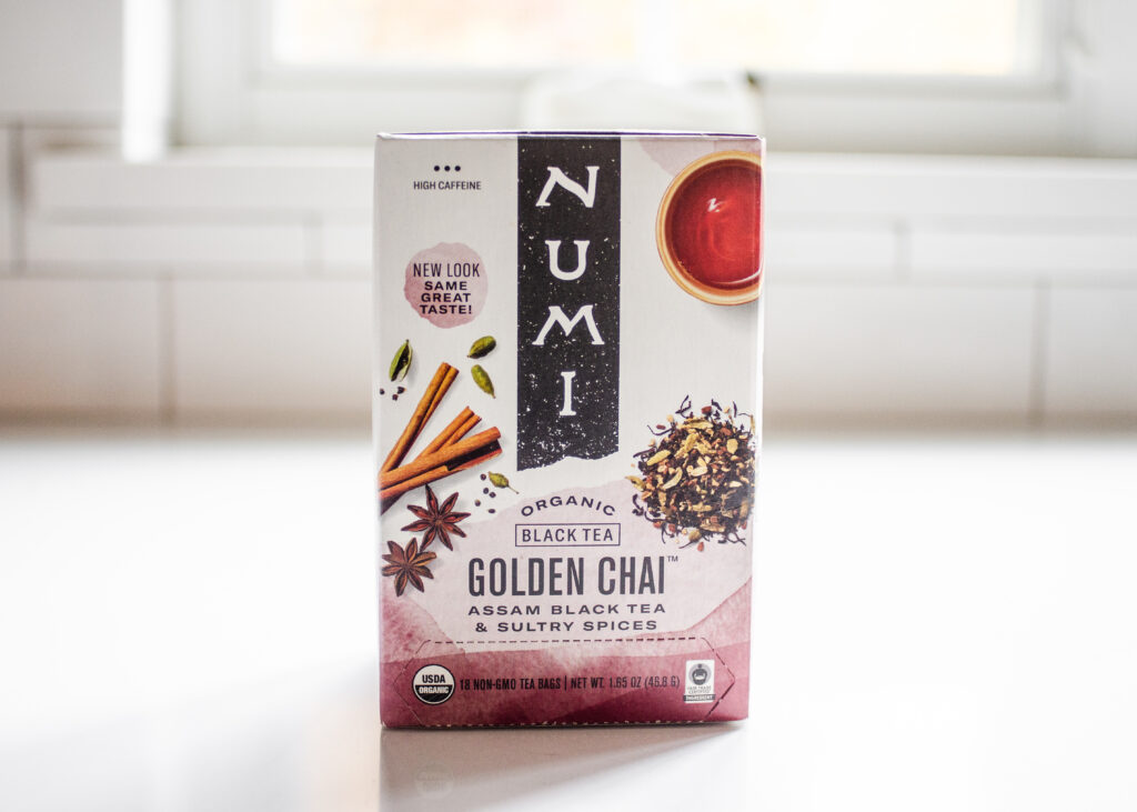 A box of Numi Golden Chai on a white countertop.