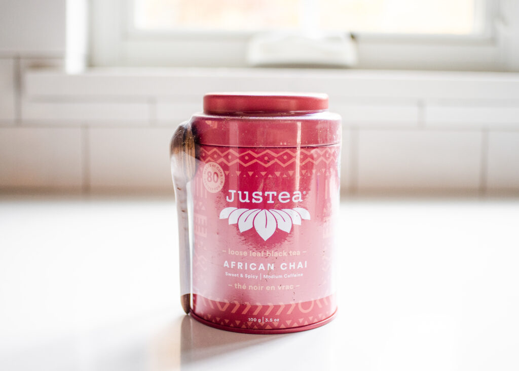 JusTea African chai tea on a white countertop with a window in the background.