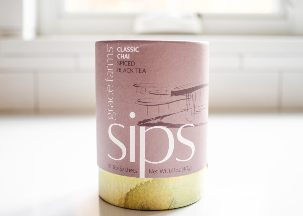 Sips organic chai tea on a white countertop.