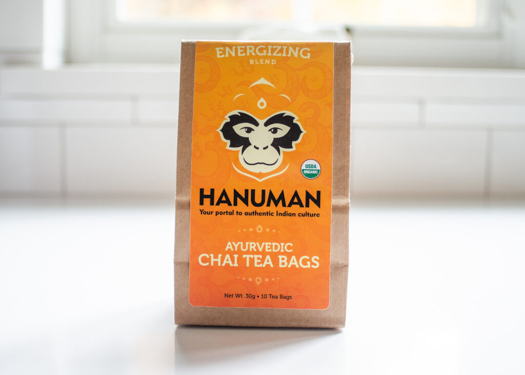 Hanuman Ayurvedic Chai Tea, energizing flavor, on a white countertop.