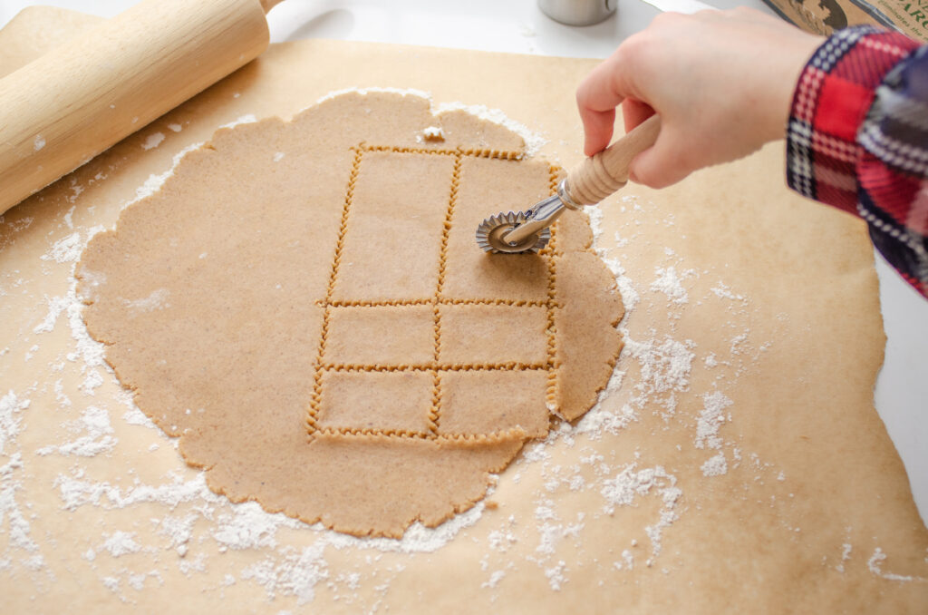 Cutting out speculoos cookies by using a pasta cutter.