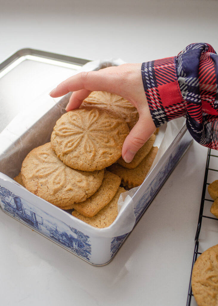 Speculaas cookies in a blue and white flip top tin.