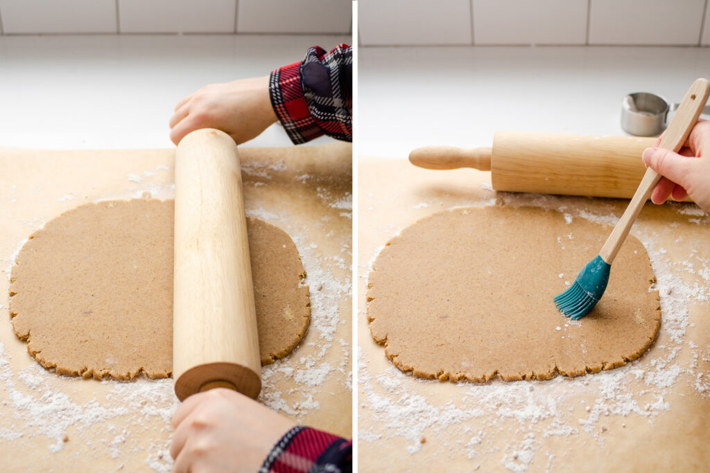 Rolling out the speculoos (AKA speculaas) dough on a sheet of floured parchment paper, then brushing off the excess flour with a pastry brush.