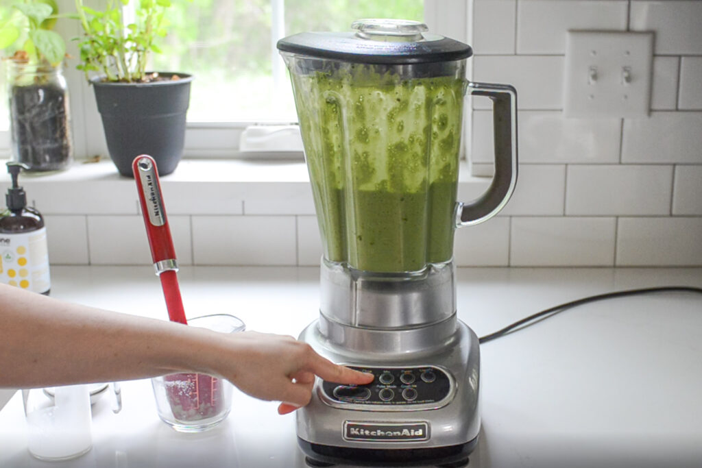 Blending the matcha Frappuccino until smooth.