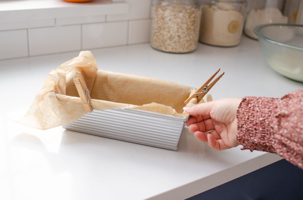 A loaf pan lined with parchment paper.