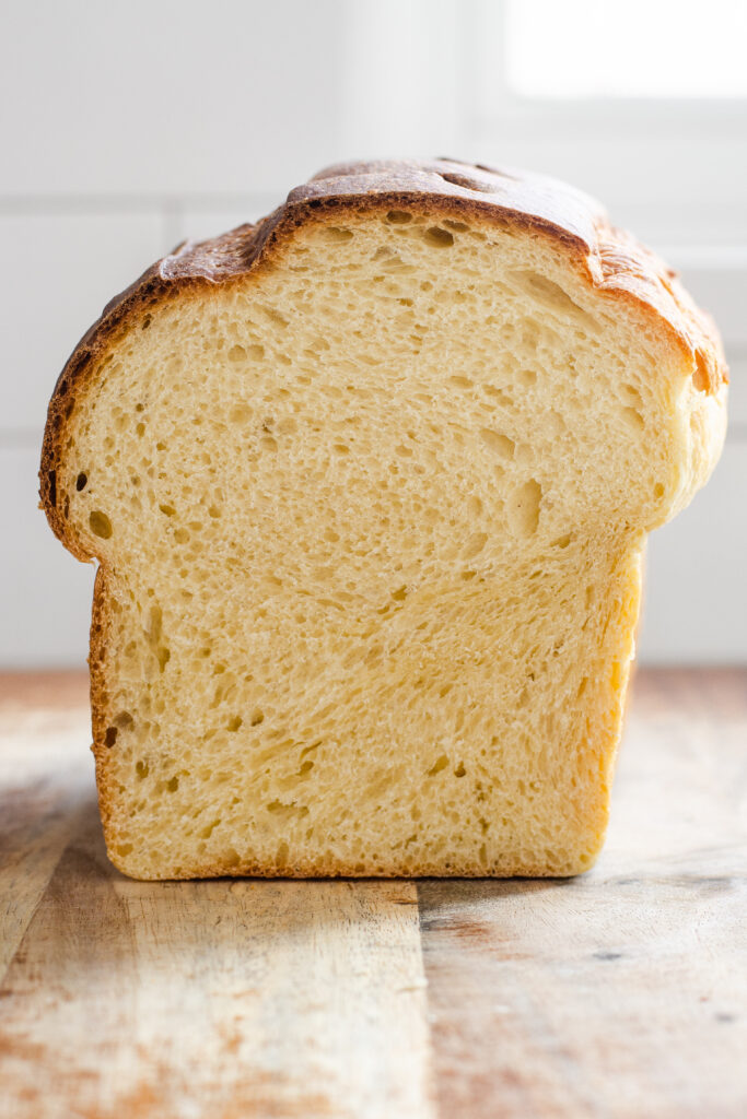 An enriched dough sourdough sandwich bread on a wooden cutting board.