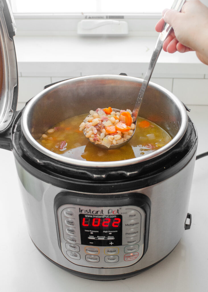 Scooping up a ladle of ham and bean soup from the Instant Pot.