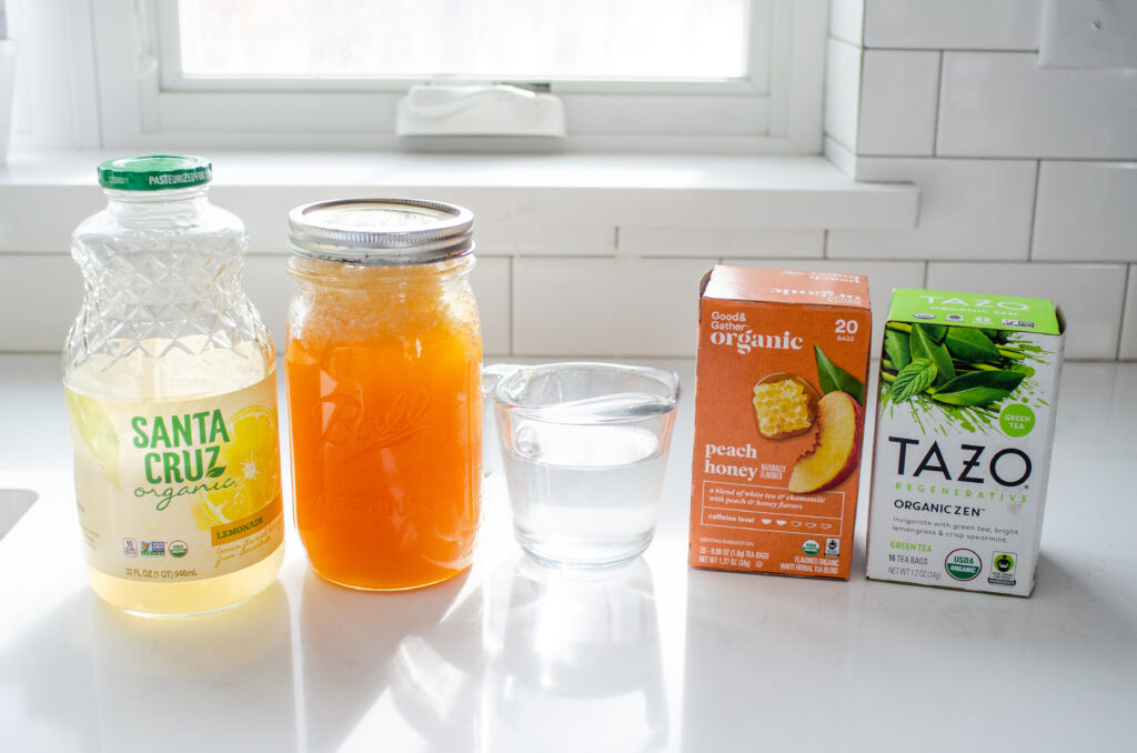 All of the ingredients needed to make the Starbucks medicine ball tea at home laid out on a white countertop with a window in the background.