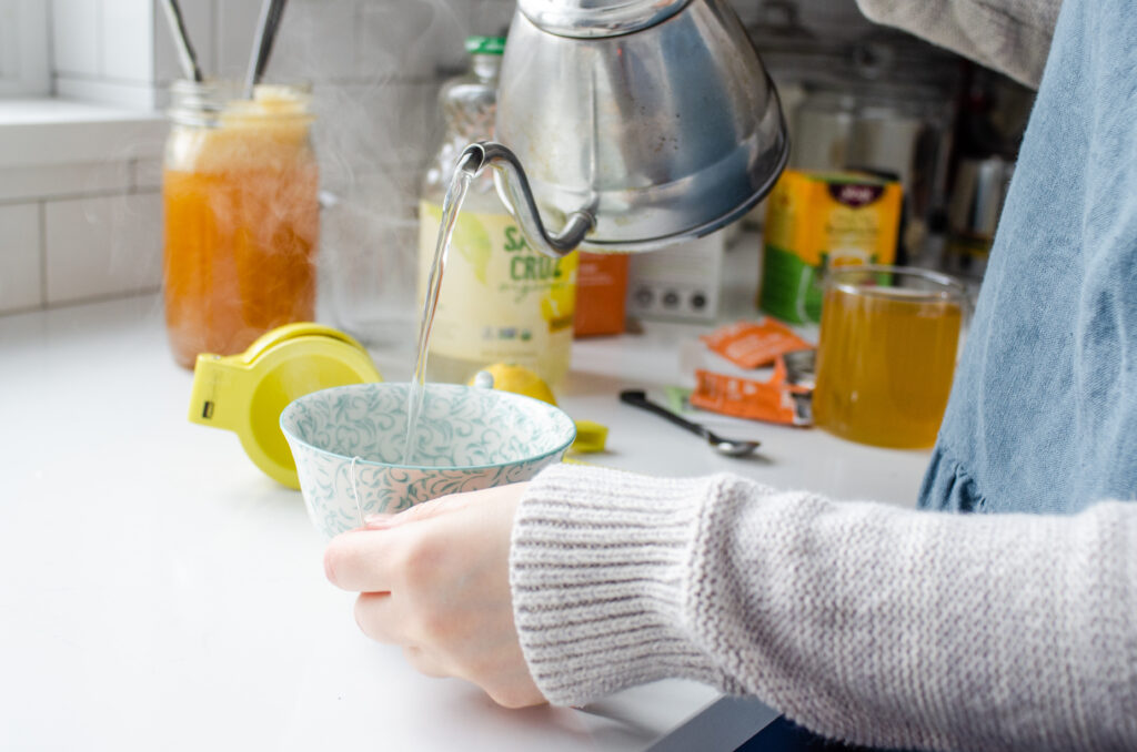 Pouring boiling water into a mug.