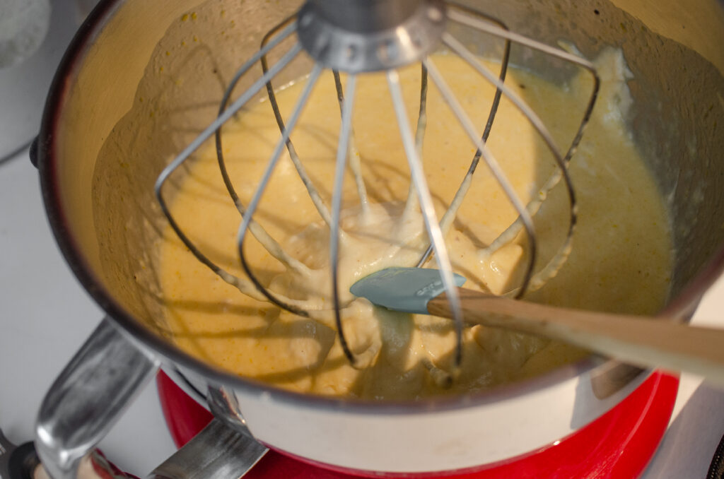 Scraping down the side and whisk attachment of the stand mixer.