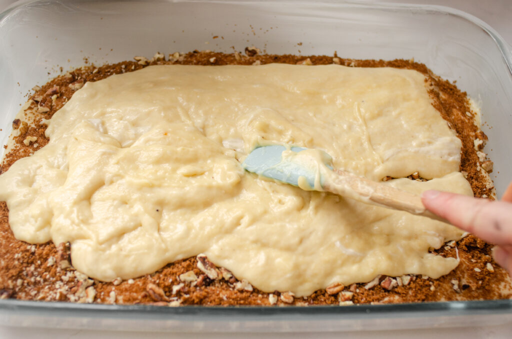 Spreading the other half of the batter on top the cinnamon sugar mixture in the pan.