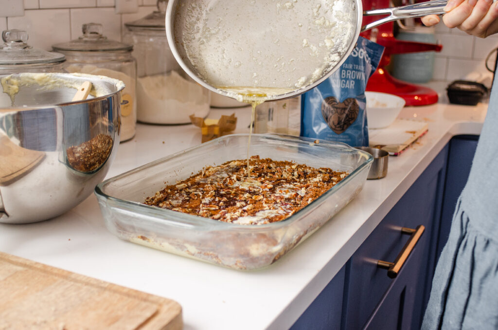 Pouring melted butter on top of the cinnamon sugar mixture.