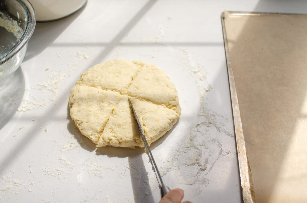 Cutting the disc of dough into 8 triangles.