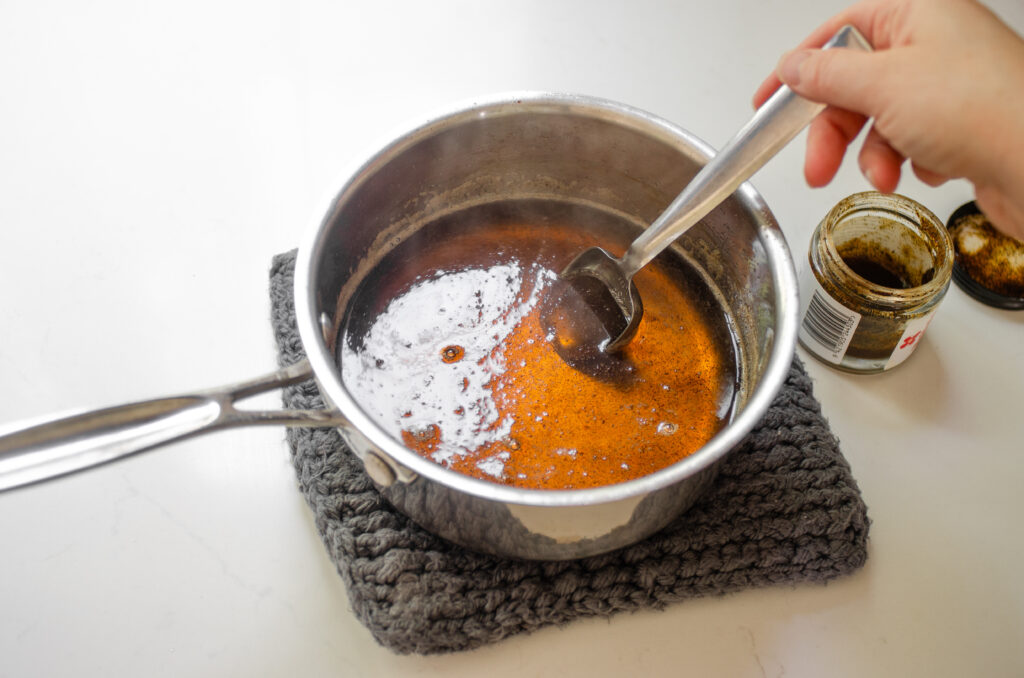 Stirring vanilla bean paste into the syrup.