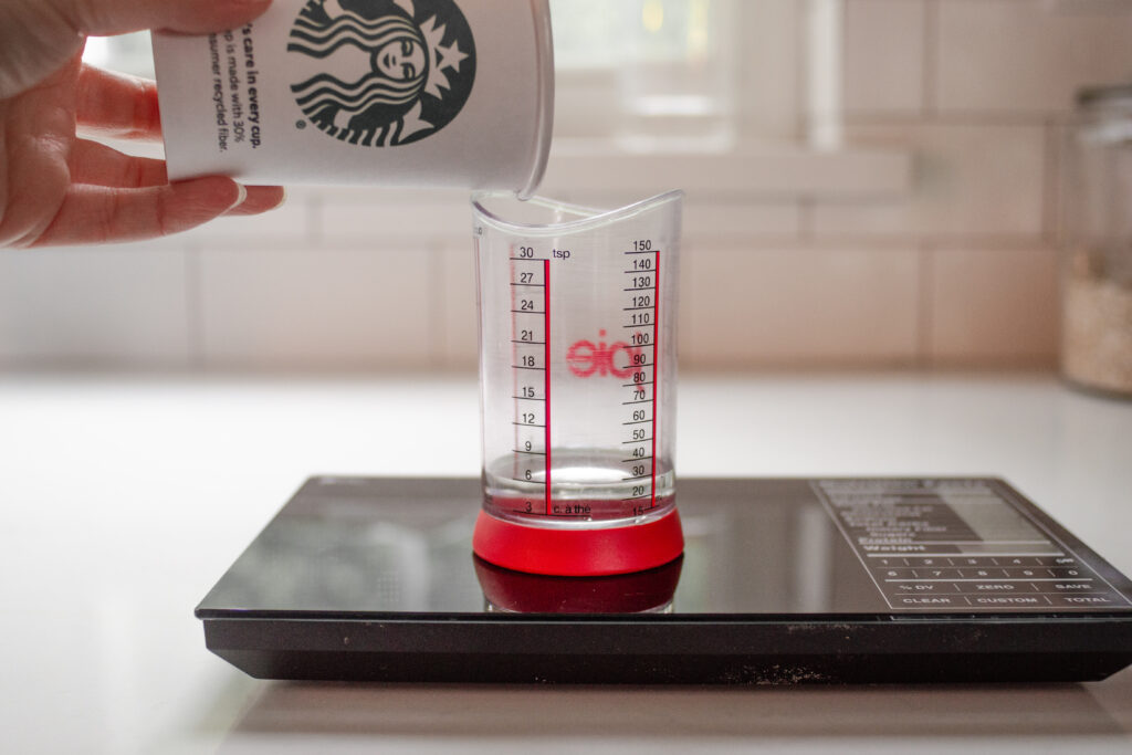 Measuring out how many tablespoons in 1 pump of Starbucks syrup.