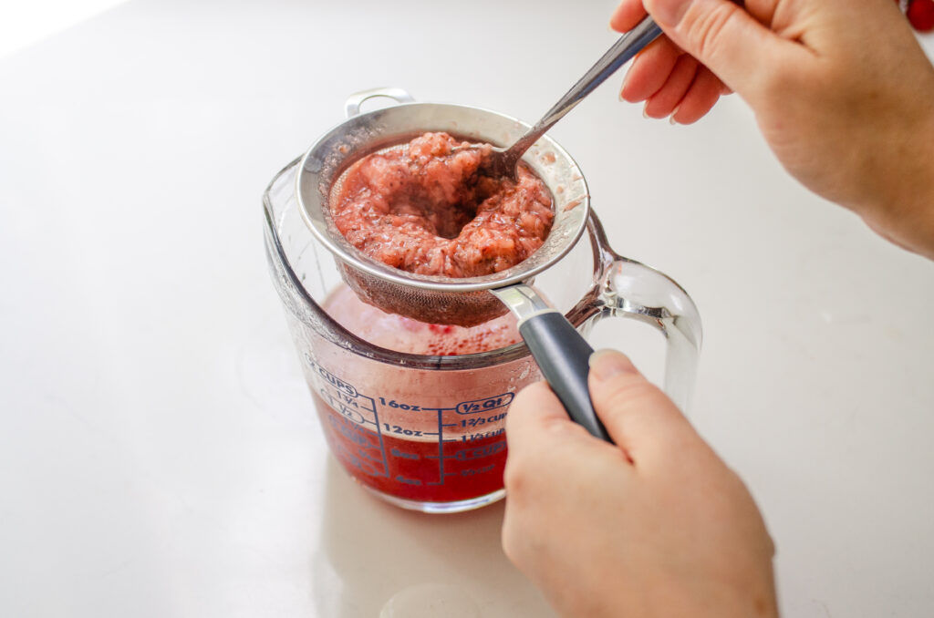 Mashing the strawberries to extract more flavor.