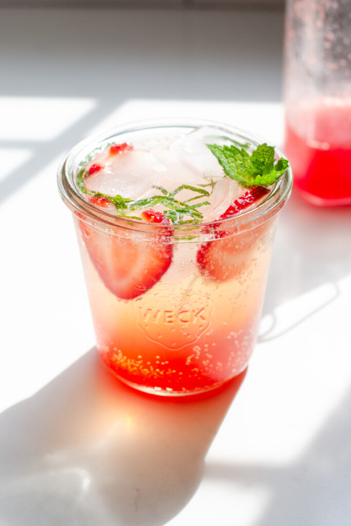 A strawberry mojito made with homemade strawberry syrup.