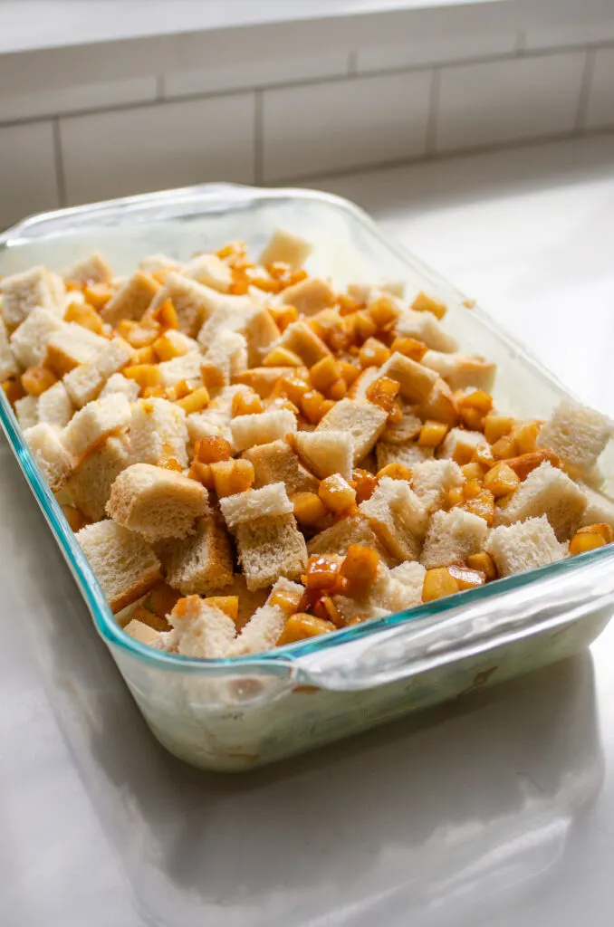 The bread and apples in a glass 13x9-inch pan.