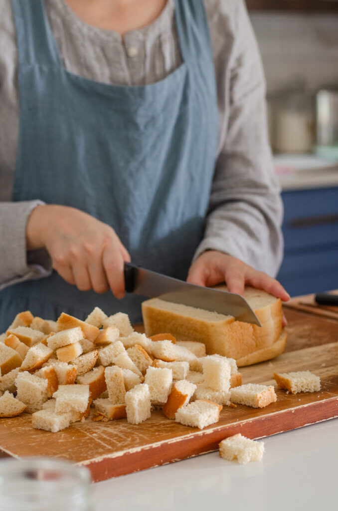 Slicing bread into cubes to use in French toast casserole.