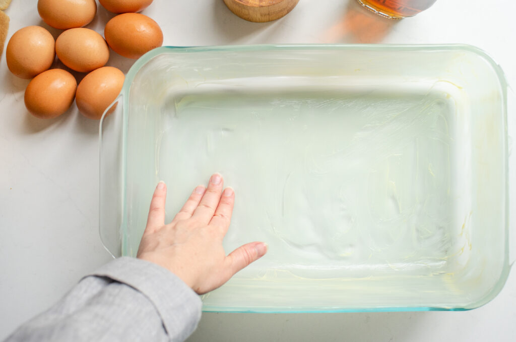 Buttering a 13x9-inch baking dish.