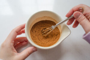 Whisking the spices with a mini whisk.