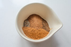 All of the spices in a little bowl with a spout.