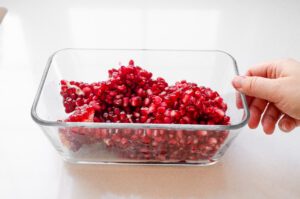 Pomegranate arils and seeds in an airtight container ready for the refrigerator. 