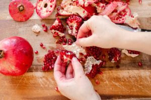 Removing the membrane from the pomegranate sections.