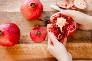 Breaking the pomegranate into sections.