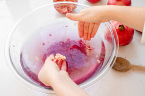 Romoving the white membranes from the the bowl of water.