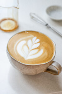 A latte made with an instant coffee espresso shot in a stoneware mug with latte art.