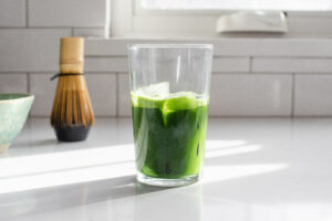 Matcha and ice in a 12 ounce glass.