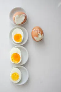 The eggs and different stages of being cooked shown side-by-side.