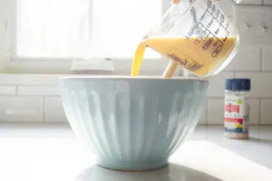 Pouring the wet ingredients into the dry ingredients.