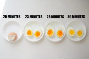 Baked hard boiled eggs in bowls to show what different baking times result in.