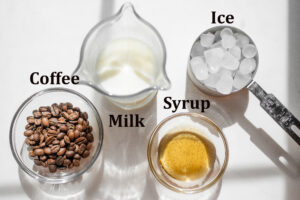 All of the ingredients needed to make a Starbucks iced vanilla latte at home.