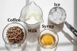 All of the ingredients needed to make a Starbucks iced vanilla latte at home.