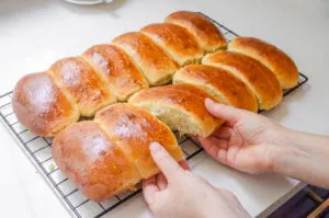 Pulling apart the cooled sourdough hotdog buns.