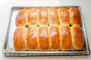 The baked hotdog buns in the sheet pan.