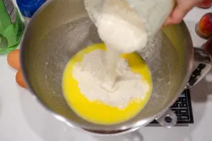 Pouring the sourdough starter on top of the butter/milk mixture.