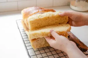 Slicing the hotdog bun sideways or horizontally. 