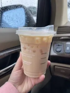 Taste testing the iced Starbucks blonde vanilla latte.