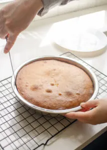 Running a knife around the edge of the cake.