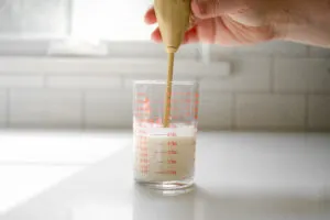 Making whipped cream with a hand held frother. 