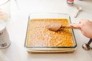 Mixing the batter into the butter in the pan.