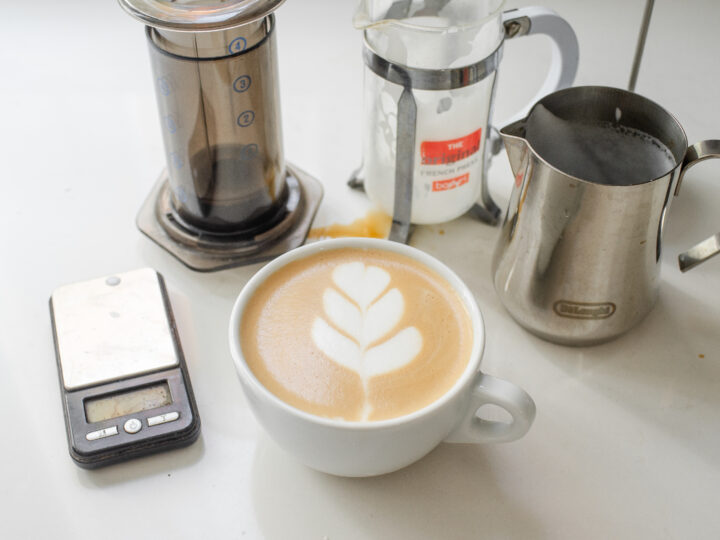 A white mug with a homemade latte and tulip latte art.